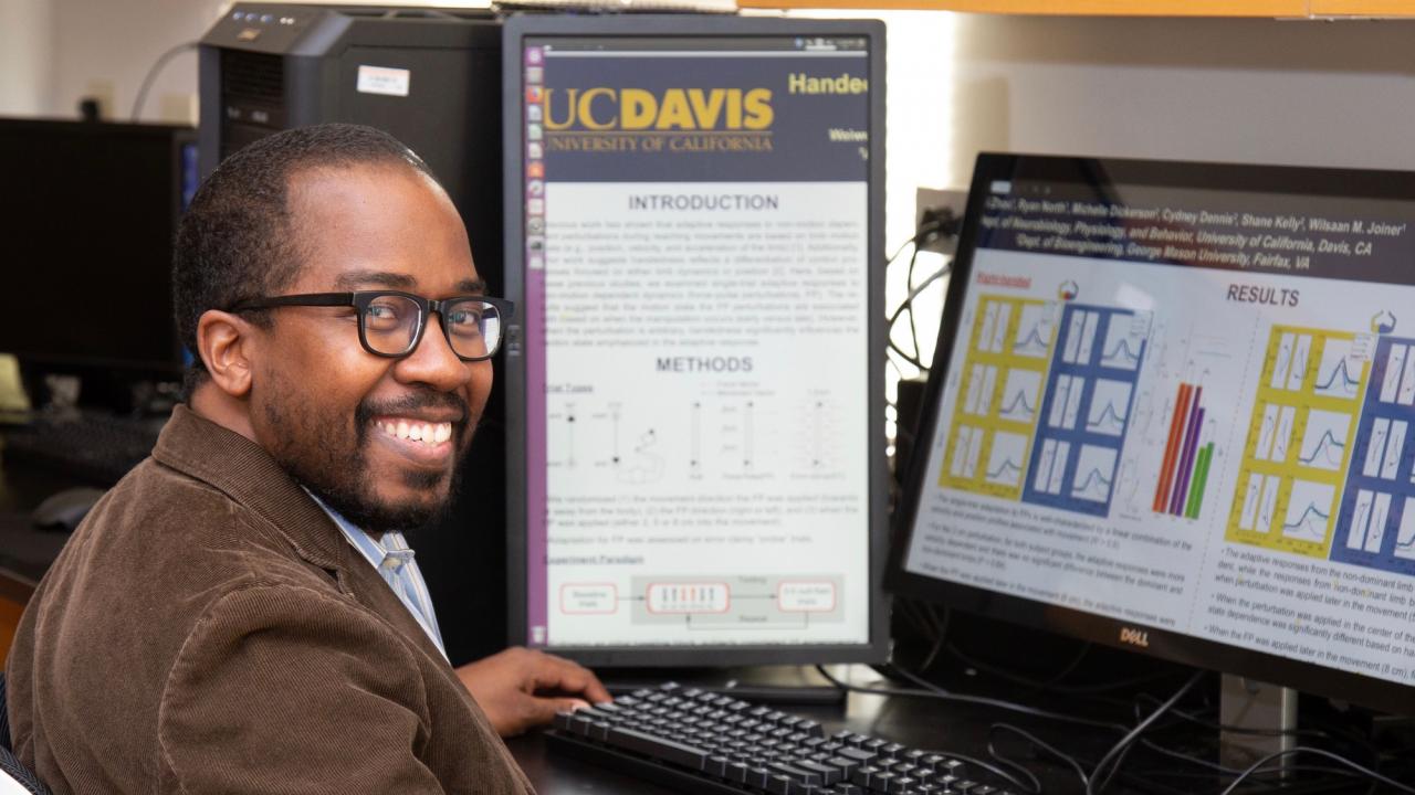 Wilsaan Joiner, PhD, in front of computer showing his research results