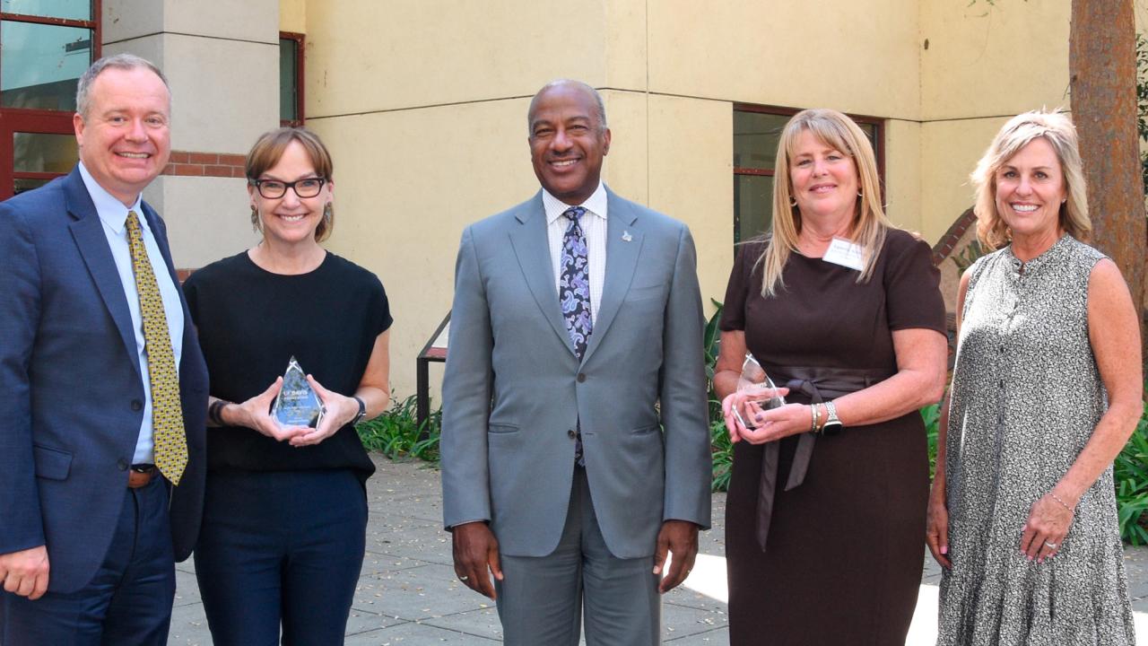 Chancellor Gary S. May, center, is flanked by Faculty and Staff Stewardship Award recipients Kimberley McAllister, left, and Tammy Ainsley, right. Also pictured are Shaun Keister, vice chancellor, Development and Alumni Relations, and Cecelia Sullivan, chair of the UC Davis Foundation.