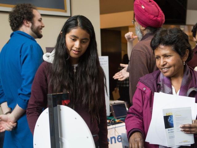 Family engaging in booth at NeuroFest